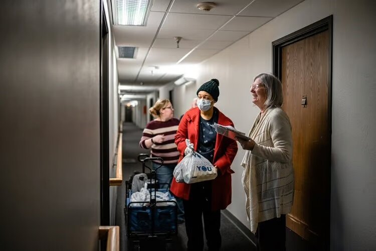 Raising Hope workers deliver food packages to Detroit seniors.